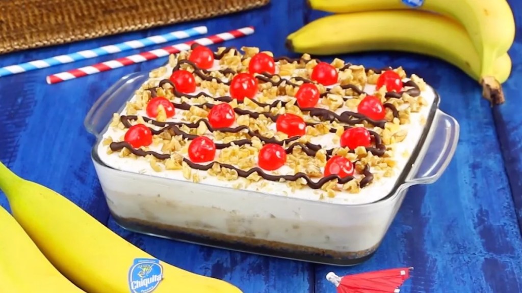 Ein Banana-Split-Kuchen in der Auflaufform mit Bananen im Hintergrund-