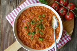 Eine Schüssel Tomatensuppe mit Linsen.